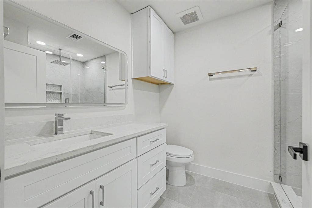 4004 Cedar Bayou Drive, Dallas, TX 75244 White vanity with an integrated rectangular sink and chrome faucet