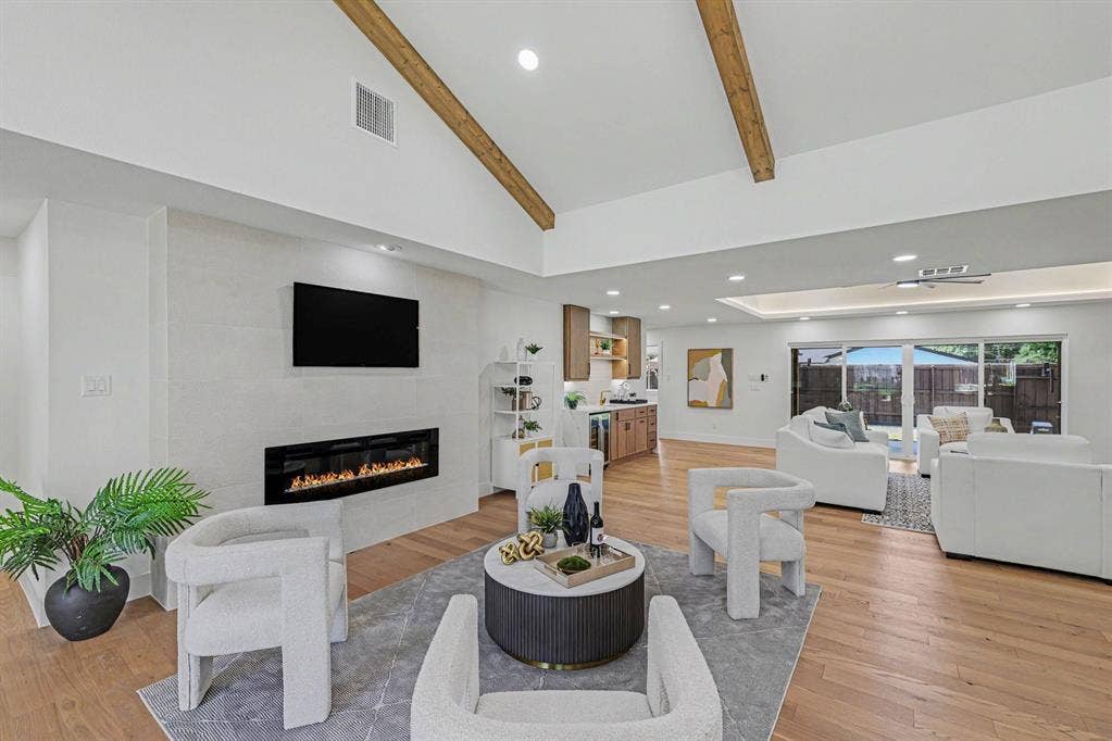 4004 Cedar Bayou Drive, Dallas, TX 75244 Vaulted ceiling with exposed wood beams, wood-finish flooring, built-in linear fireplace, recessed lighting, and sliding glass doors