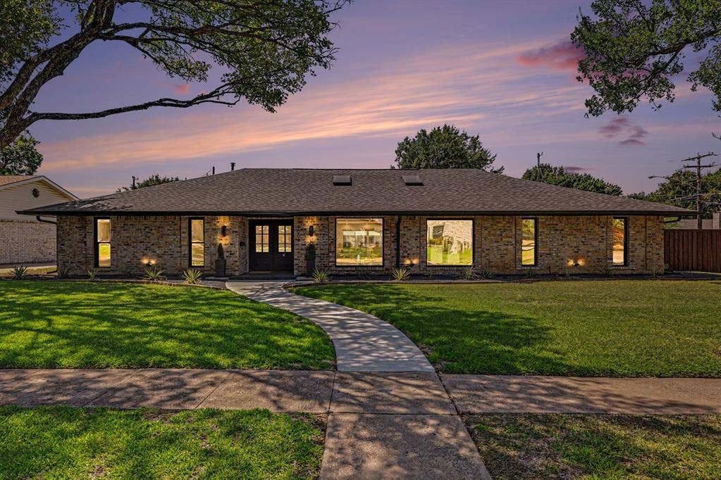 4004 Cedar Bayou Drive, Dallas, TX 75244 Brick exterior, dual entry doors, multiple large windows, and a concrete walkway