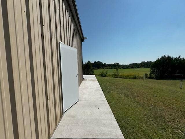 Corrugated metal siding exterior with a concrete walkway