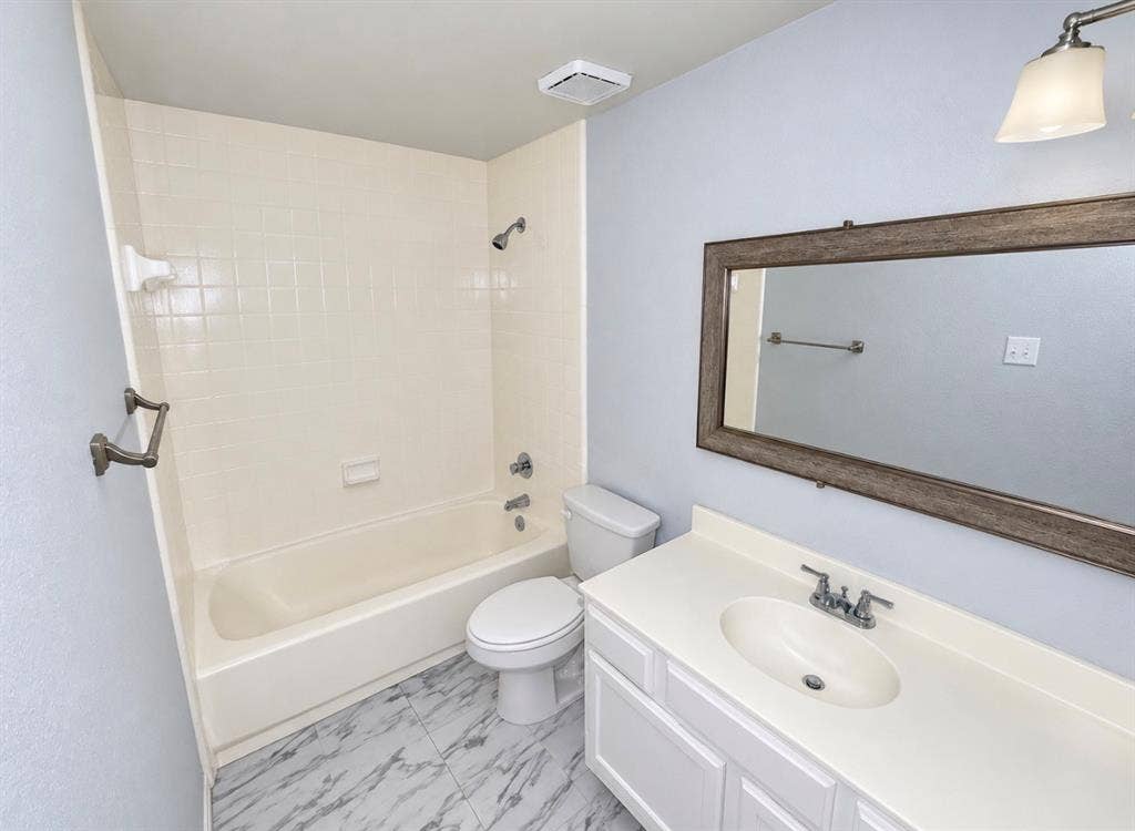 7126 Holly Hill Drive, #108, Dallas, TX 75231 White vanity with an integrated sink and chrome fixtures