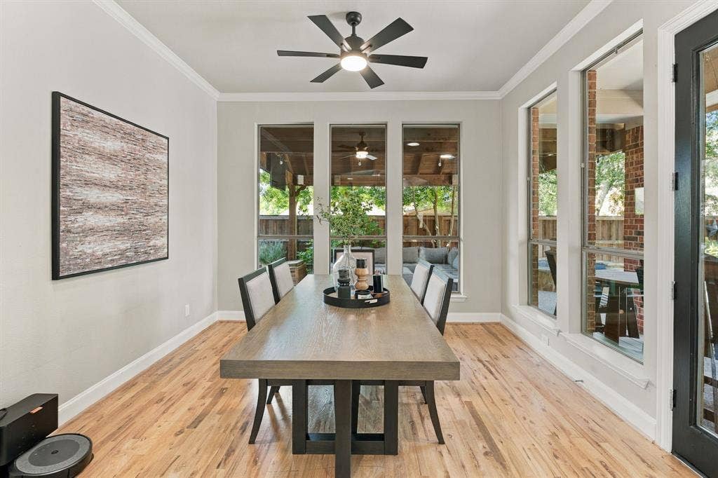 Breakfast Area, Alternate View | Window-lined dining nook overlooks the backyard and connects directly to the kitchen and outdoor living area.
