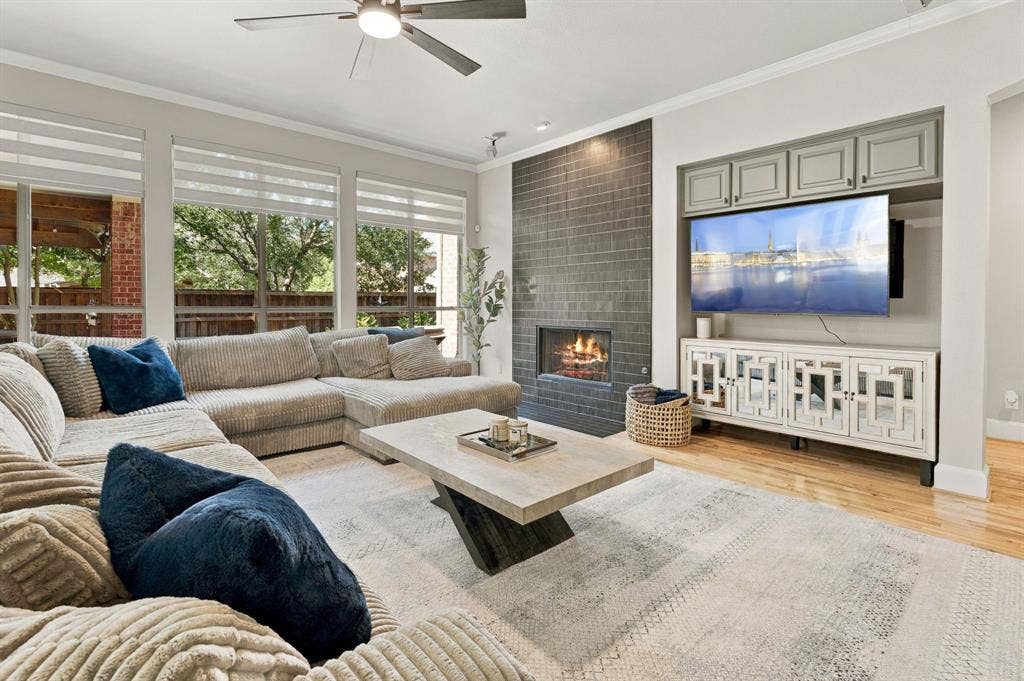 Family Room | Main living area with a newly tiled fireplace, built-in cabinetry and large windows overlooking the backyard pool.