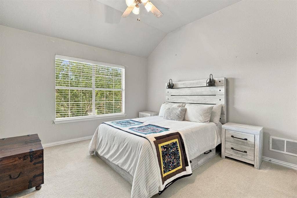 Upstairs Secondary Bedroom | Bright bedroom with carpet, a ceiling fan and a large window, providing flexible sleeping or guest space.
