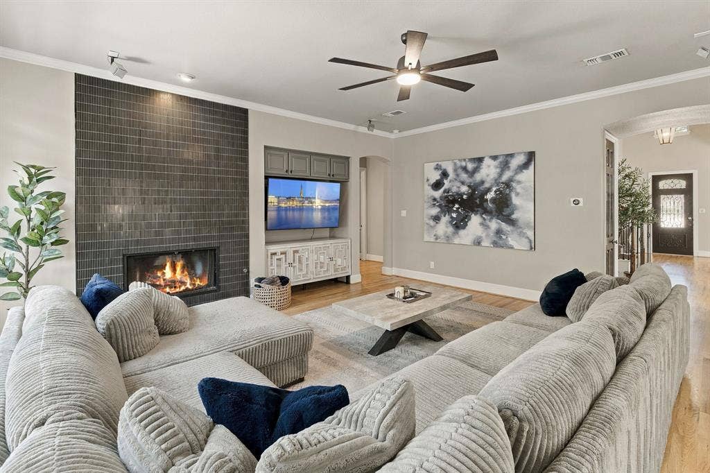 Family Room, Alternate View | Spacious main-level gathering room with a ceiling fan, recessed lighting, fireplace and open circulation to adjoining living spaces.