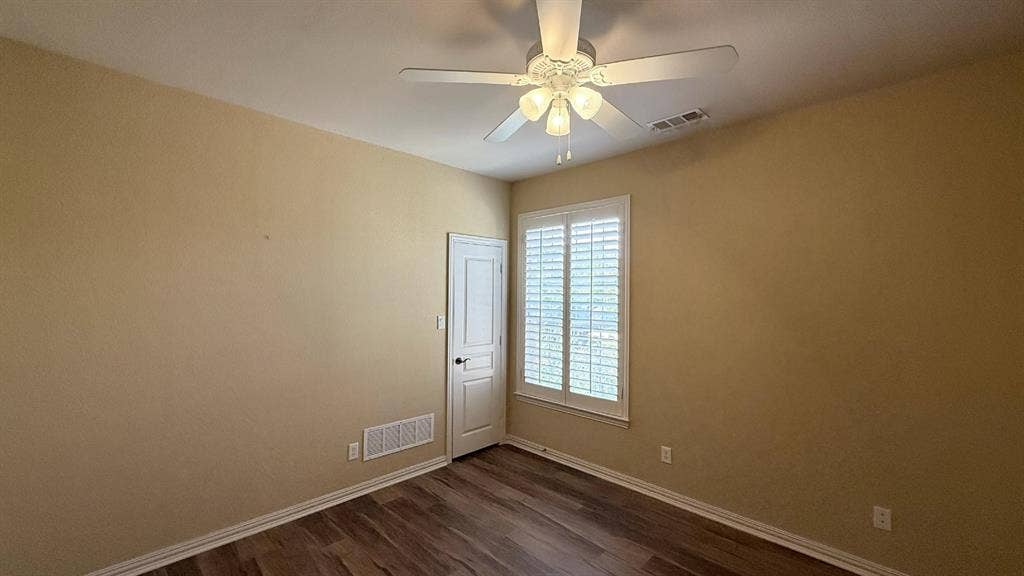 5700 Travis Drive, Frisco, TX 75034 Wood-finish flooring, plantation shutters, ceiling fan with light fixture, and a solid core door