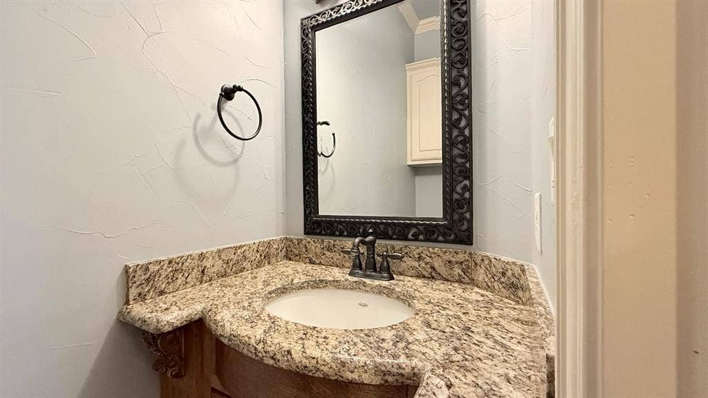 5700 Travis Drive, Frisco, TX 75034 Built-in vanity with a stone countertop and an undermount sink
