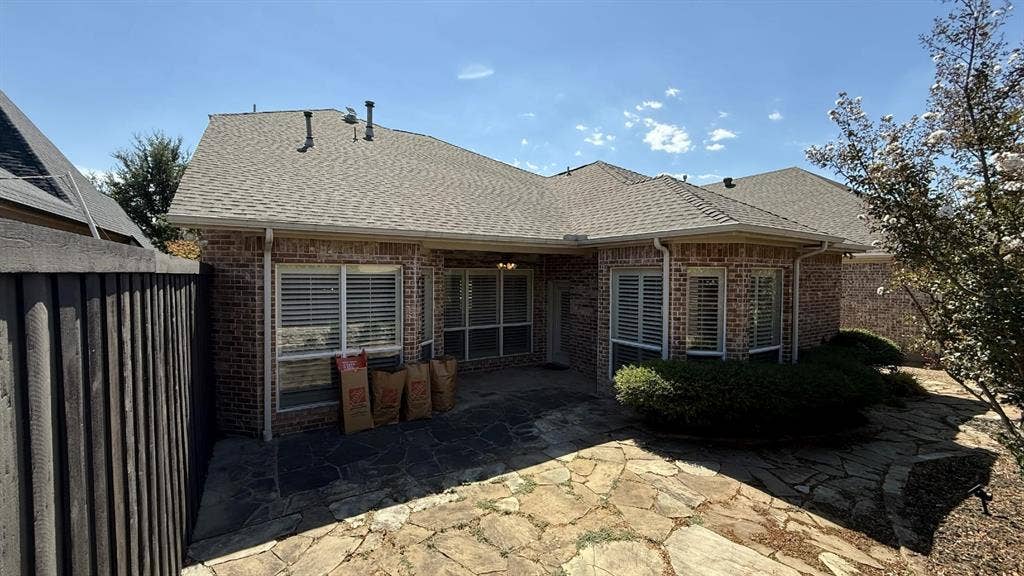 5700 Travis Drive, Frisco, TX 75034 Brick exterior with a shingle roof and white gutters