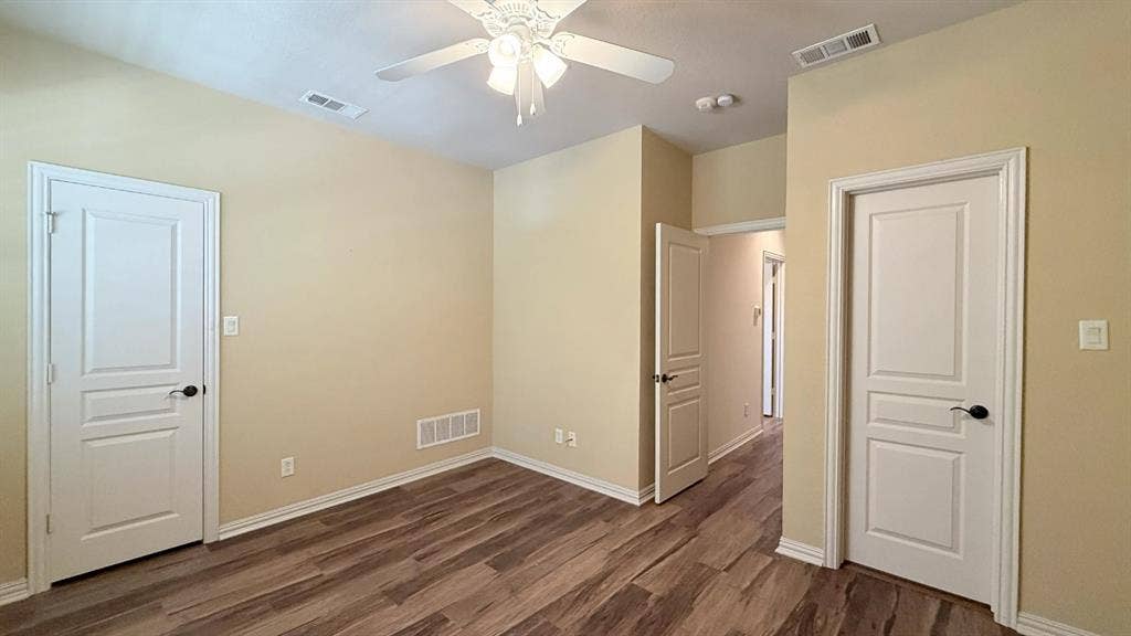 5700 Travis Drive, Frisco, TX 75034 Wood-finish flooring, white paneled doors, ceiling fan with integrated lighting, and neutral wall tones