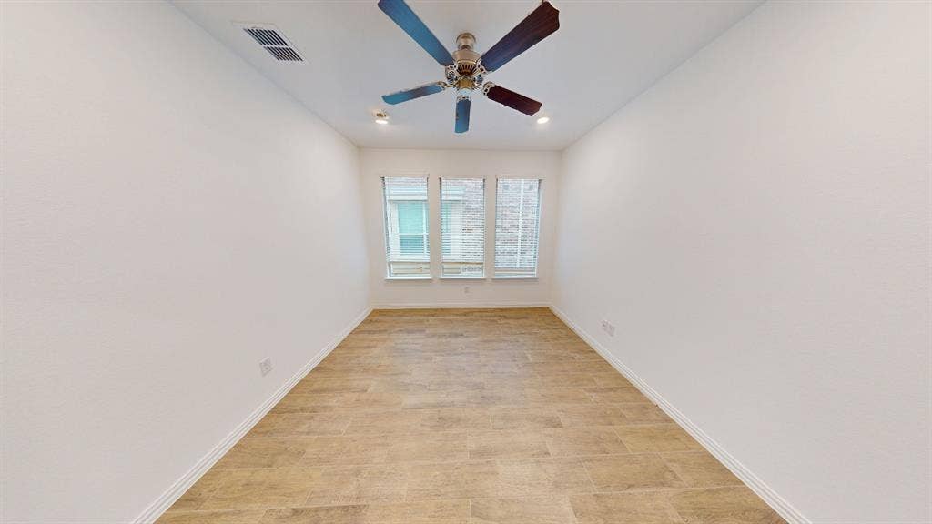 Recessed lighting, ceiling fan, three windows, wood-finish flooring, white wall paint
