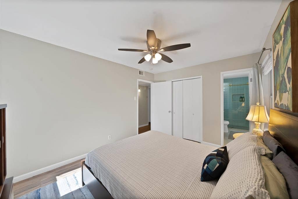 1400 Lorrie Drive, Richardson, TX 75080 Bedroom with ceiling fan, a closet, wood finished floors, and connected bathroom