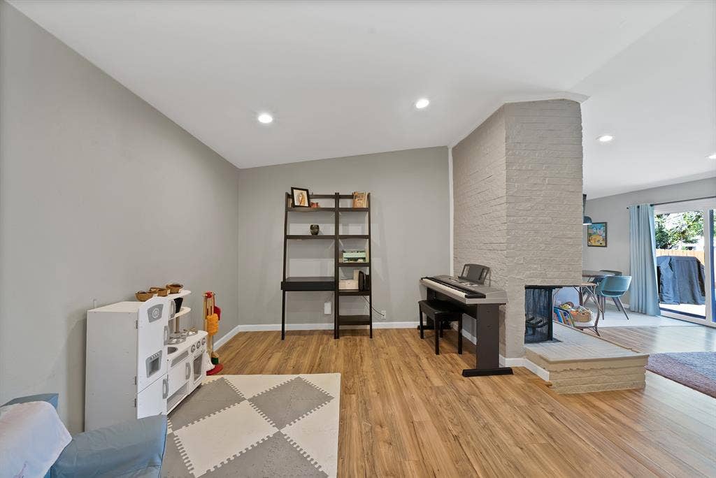 1400 Lorrie Drive, Richardson, TX 75080 Rec room featuring light wood-style floors, recessed lighting, and a fireplace