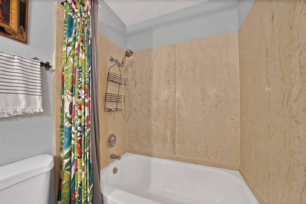 1400 Lorrie Drive, Richardson, TX 75080 Full bath with shower / bath combo and a textured wall