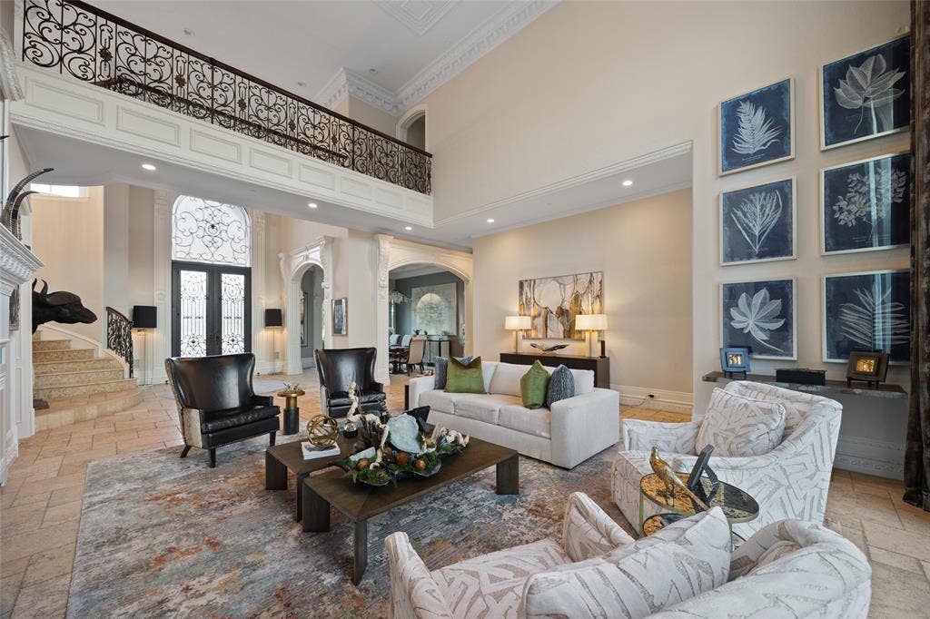 6300 Caroline Drive, Frisco, TX 75034 Two-story living area with high ceilings, wrought iron balcony railing, and ornate double entry doors