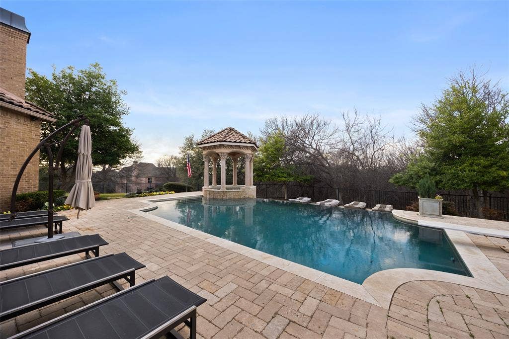6300 Caroline Drive, Frisco, TX 75034 Resort-style pool with integrated gazebo, expansive paver patio, and stone coping