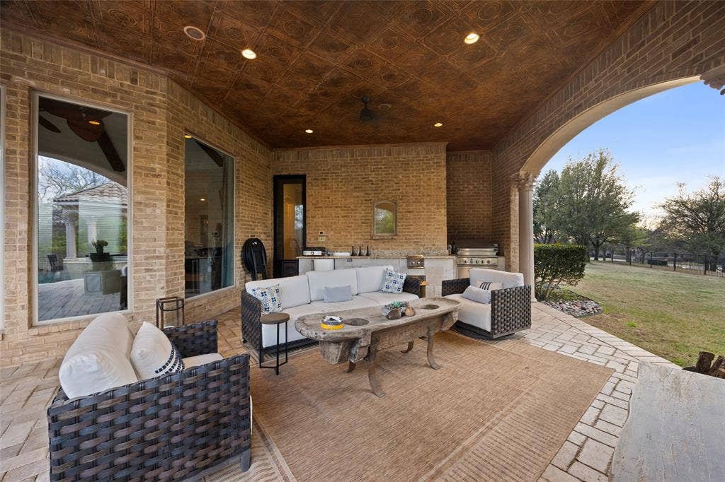 6300 Caroline Drive, Frisco, TX 75034 Covered patio featuring a patterned ceiling, brick walls, and an arched walkway