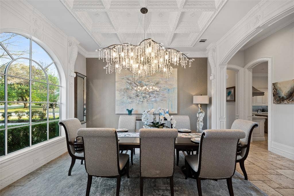 6300 Caroline Drive, Frisco, TX 75034 Coffered ceiling with a crystal chandelier, arched window, and decorative trim work