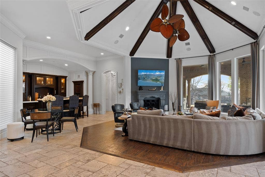 6300 Caroline Drive, Frisco, TX 75034 Vaulted ceiling with exposed wood beams and a decorative ceiling fan