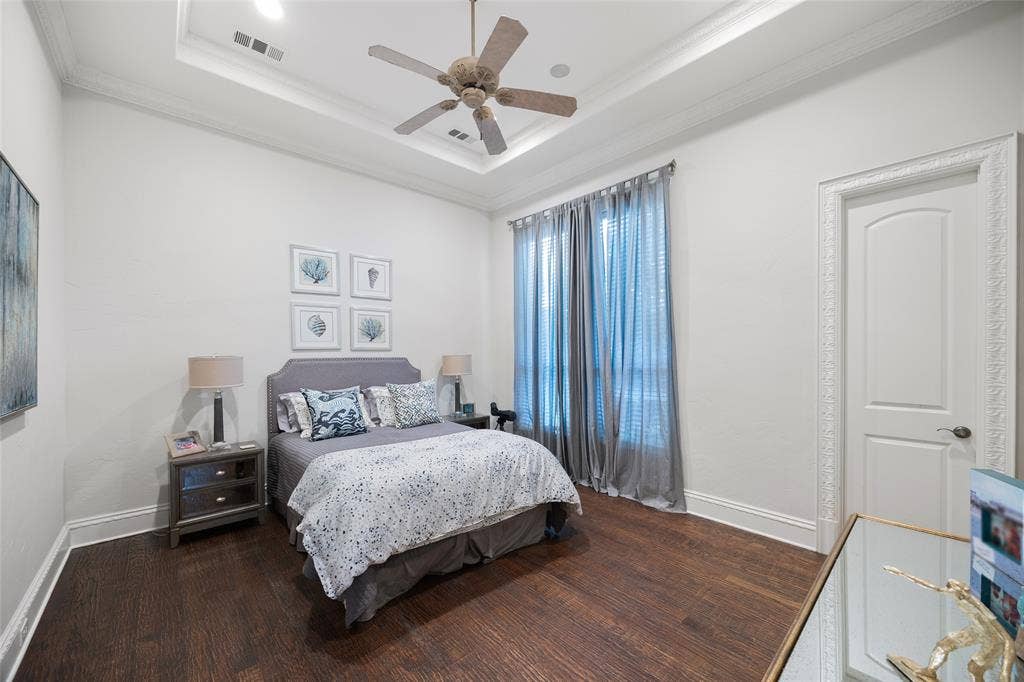 6300 Caroline Drive, Frisco, TX 75034 Wood-finish flooring, tray ceiling with crown molding, ceiling fan, and window with full-length drapery