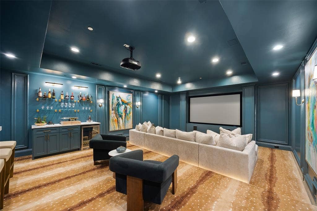6300 Caroline Drive, Frisco, TX 75034 Integrated projection screen, built-in wet bar with cabinetry, recessed ceiling lighting, wall-mounted sconces, and patterned flooring