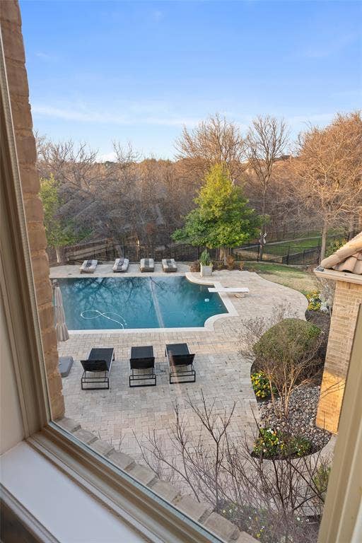 6300 Caroline Drive, Frisco, TX 75034 Outdoor swimming pool with integrated diving board, surrounded by stone paver patio