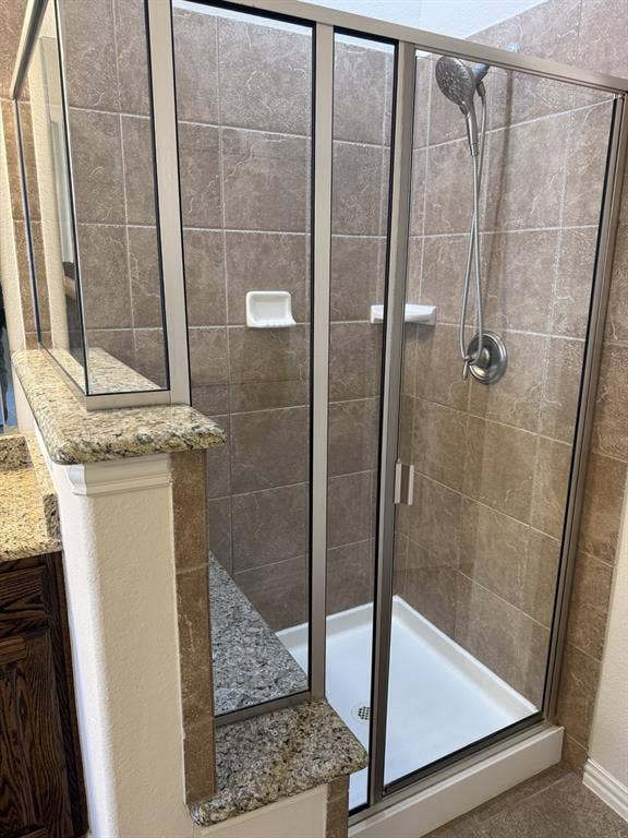 13721 Vera Cruz Road, Frisco, TX 75035 Glass-enclosed shower with a white acrylic pan and tile surround