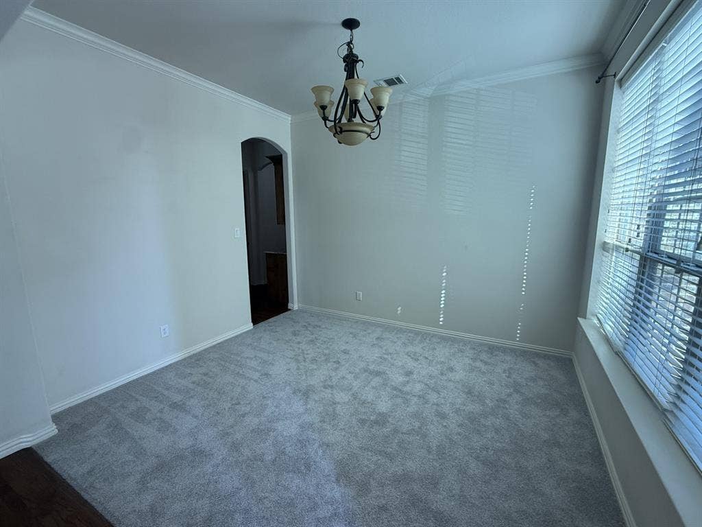 13721 Vera Cruz Road, Frisco, TX 75035 Recessed window with blinds, ceiling-mounted chandelier, light-toned wall paint, and gray carpet flooring