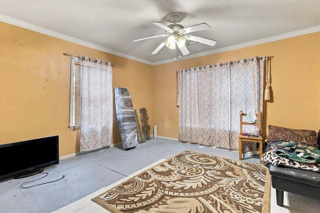 Room featuring neutral wall tones, multi-pane window configurations, and a central ceiling fan with integrated lighting