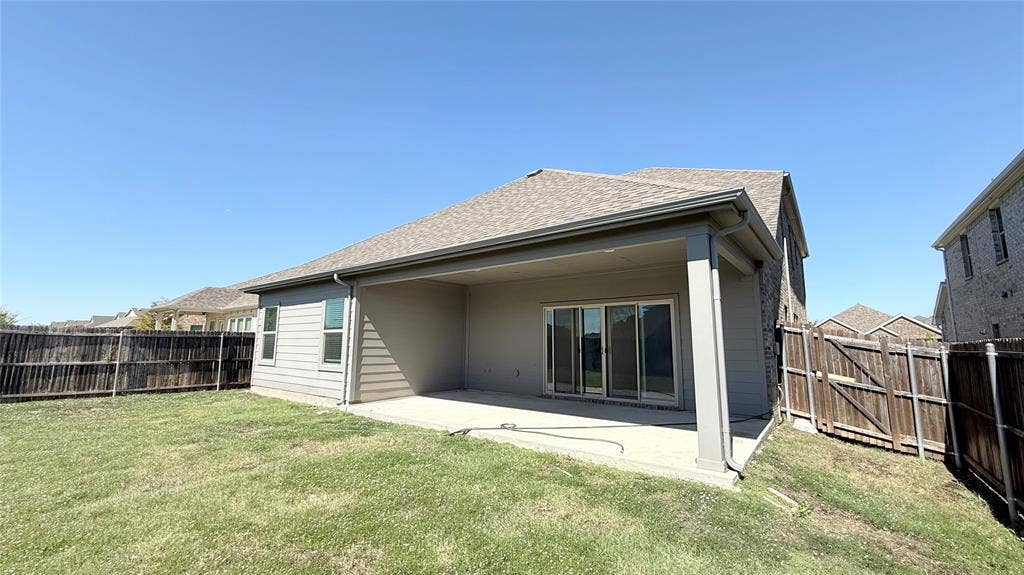 531 Deer Canyon Way, Princeton, TX 75407 Covered patio with a concrete slab, sliding glass doors, and a partial brick exterior