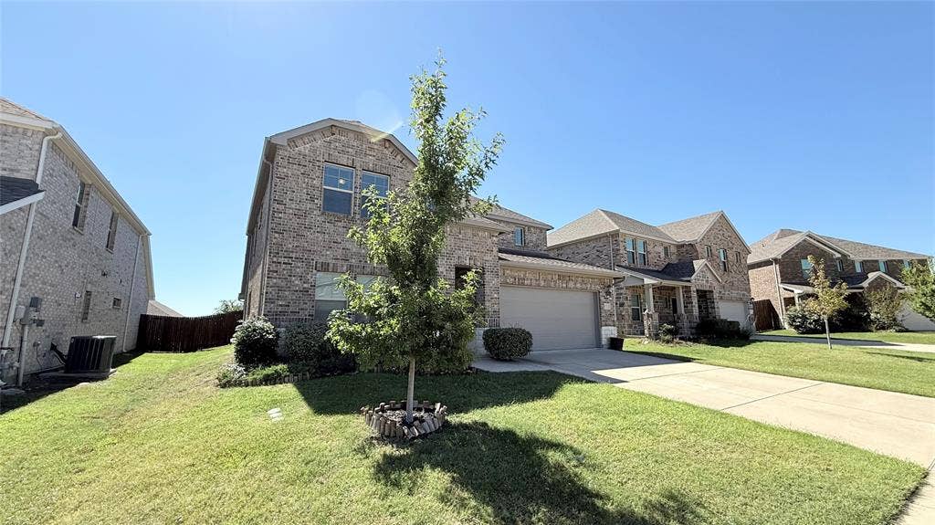531 Deer Canyon Way, Princeton, TX 75407 Two-story brick exterior with an attached garage, gabled roofline, and front landscaping