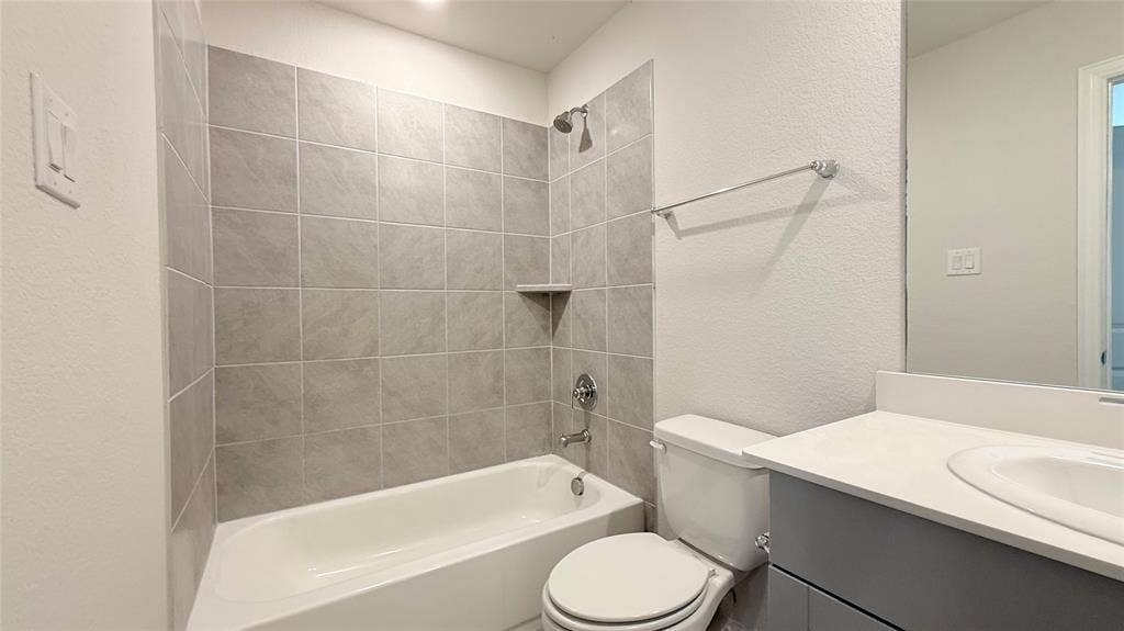 531 Deer Canyon Way, Princeton, TX 75407 White ceramic bathtub with gray subway tile surround, chrome shower fixtures, and a built-in shower shelf