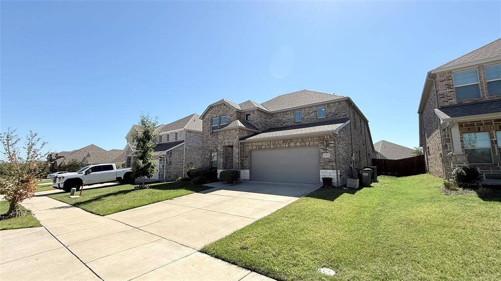 531 Deer Canyon Way, Princeton, TX 75407 Two-story brick exterior with an attached garage, concrete driveway, and a manicured lawn
