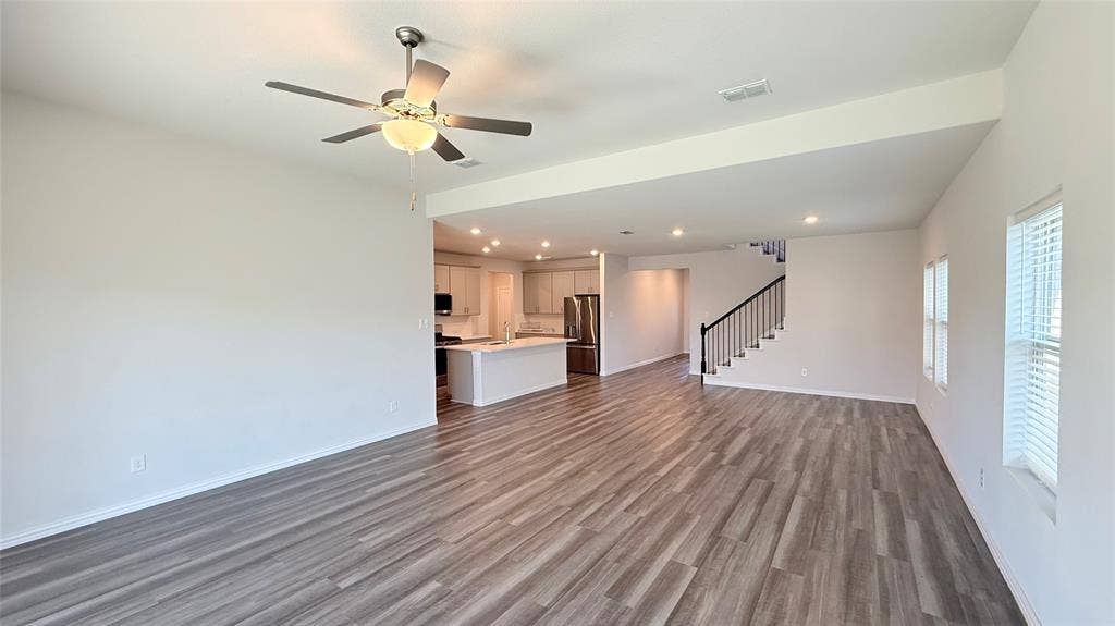 531 Deer Canyon Way, Princeton, TX 75407 Open-concept living area with wood-finish flooring, a contemporary ceiling fan, and recessed lighting