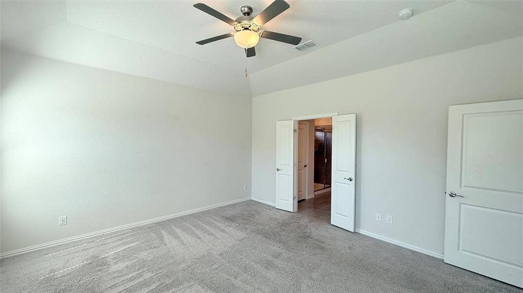 531 Deer Canyon Way, Princeton, TX 75407 Vaulted ceiling with a contemporary ceiling fan, light gray carpeting, and white paneled doors
