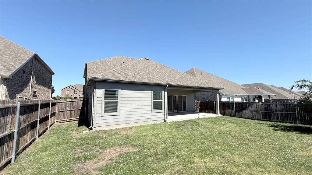 531 Deer Canyon Way, Princeton, TX 75407 Expansive green space with a wood privacy fence, covered patio, and dual-pane windows