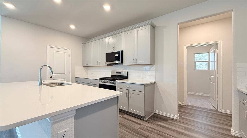 531 Deer Canyon Way, Princeton, TX 75407 Kitchen featuring light gray cabinetry, white countertops, stainless steel appliances, and wood-finish flooring