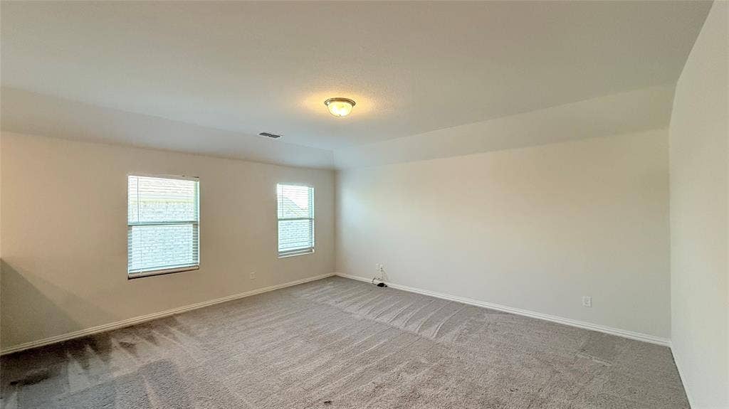 531 Deer Canyon Way, Princeton, TX 75407 Soft gray carpeting, two windows with blinds, recessed ceiling light, and neutral wall paint