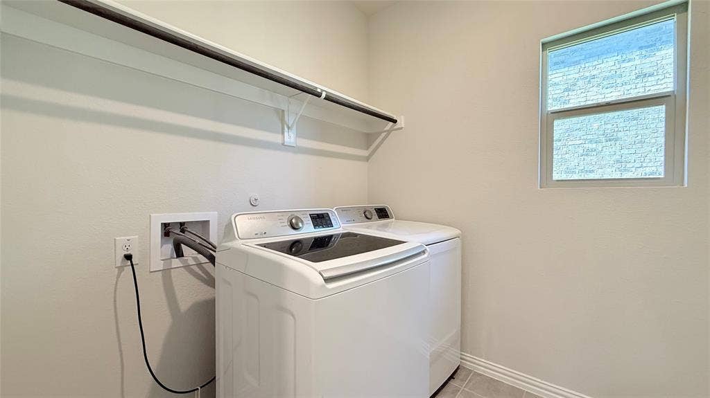 531 Deer Canyon Way, Princeton, TX 75407 Laundry area with tile flooring, a single window, and a built-in shelf with a hanging rod