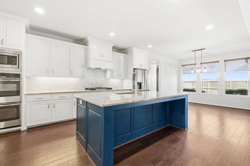 1839 Legendary Reef Way, St. Paul, TX 75098 Gorgeous kitchen, large center island, double ovens, pretty granite and backsplash