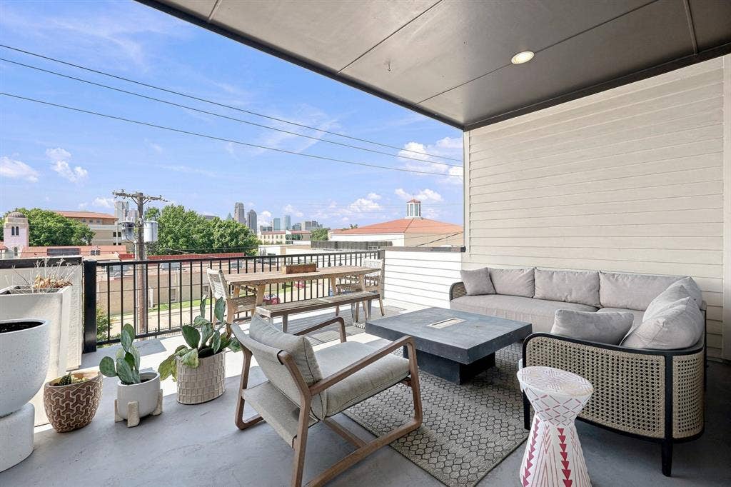 1137 Manderly Court, Dallas, TX 75204 Covered outdoor patio featuring recessed lighting, a horizontal plank wall, and a black metal railing