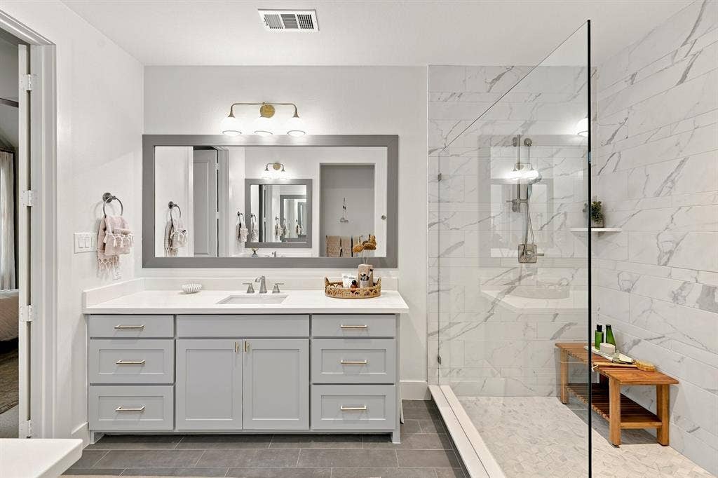 1137 Manderly Court, Dallas, TX 75204 Gray vanity with brushed nickel hardware and a white countertop