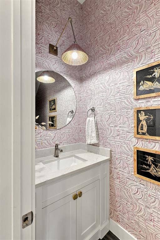 1137 Manderly Court, Dallas, TX 75204 White vanity with gold-tone hardware, rectangular undermount sink, and light-toned countertop