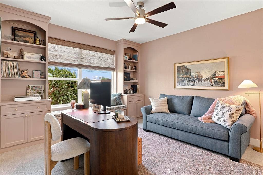 1137 Manderly Court, Dallas, TX 75204 Built-in shelving and cabinetry frame a large window with woven shades