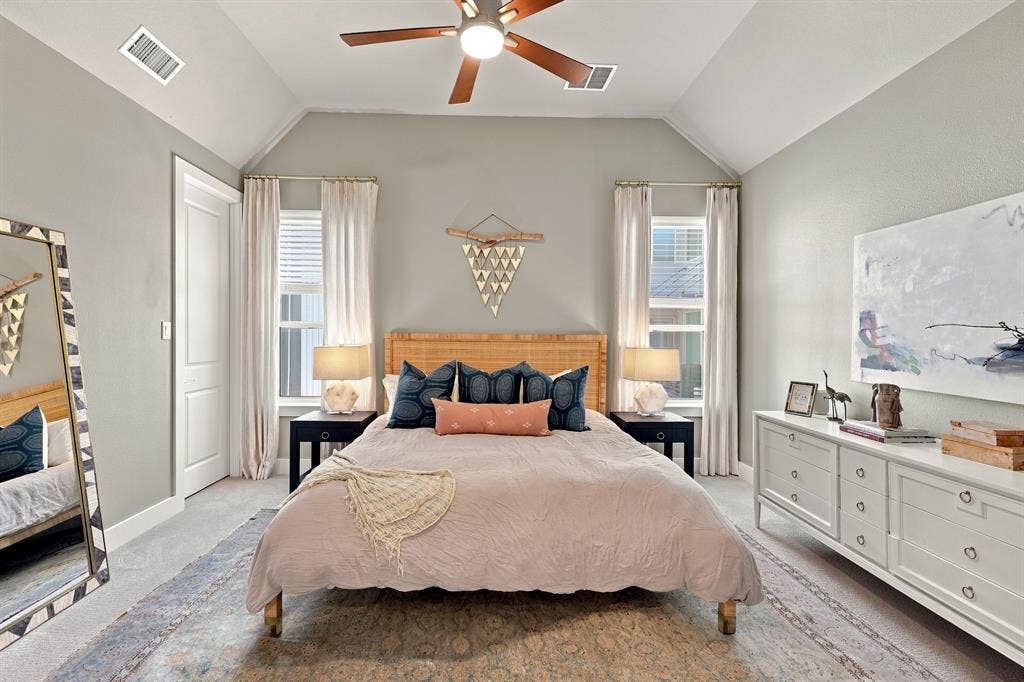 1137 Manderly Court, Dallas, TX 75204 Vaulted ceiling with an attached ceiling fan, dual windows with blinds, light-colored walls, and carpeting