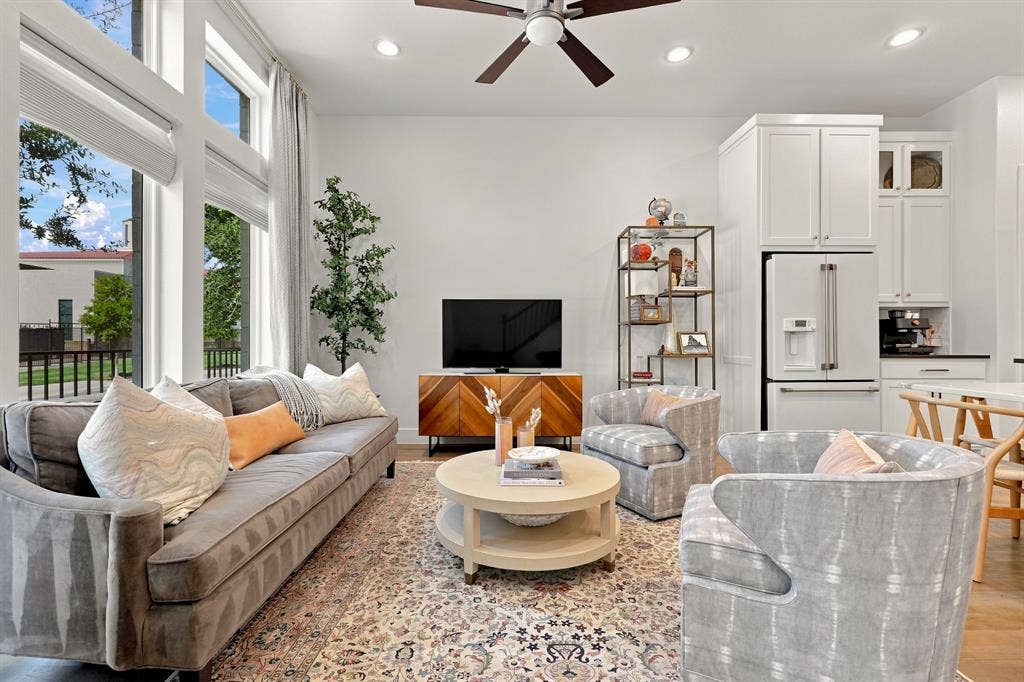 1137 Manderly Court, Dallas, TX 75204 Tall windows with transom detailing, recessed lighting, ceiling fan, wood-finish flooring, and white cabinetry