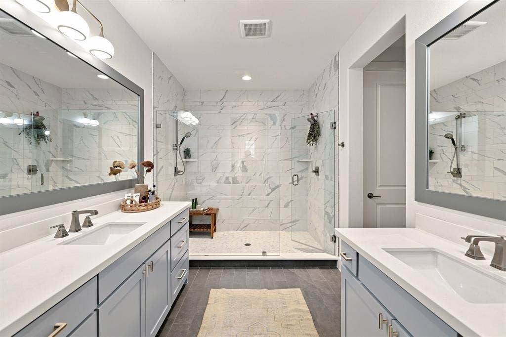 1137 Manderly Court, Dallas, TX 75204 Dual vanities with white countertops, matte gray cabinetry, and brushed nickel fixtures