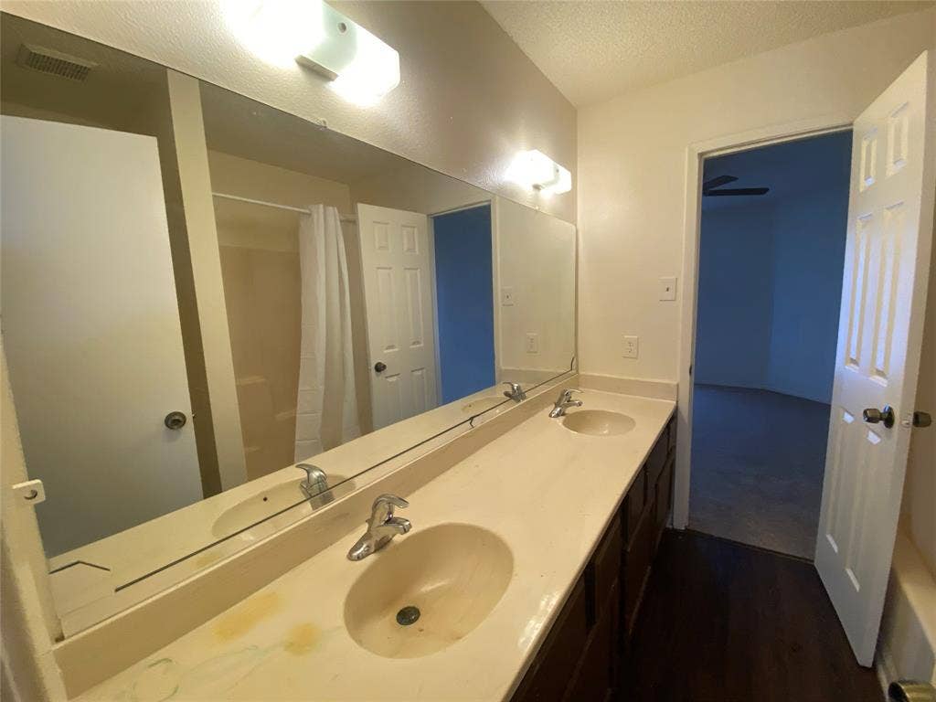 2802 Wimbledon Court, #B, Garland, TX 75041 Full bathroom featuring a sink, wood finished floors, and visible vents