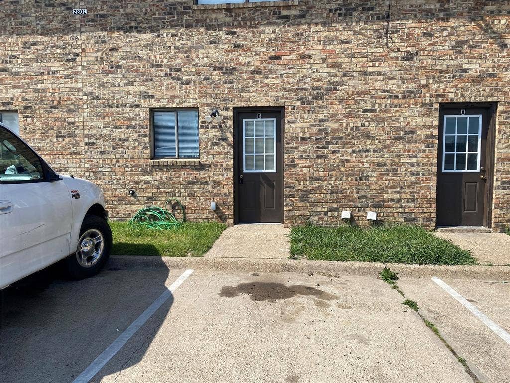 2802 Wimbledon Court, #B, Garland, TX 75041 Doorway to property featuring uncovered parking