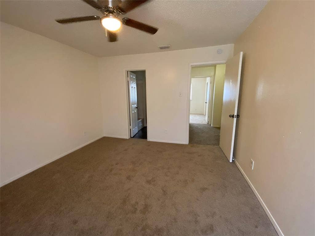 2802 Wimbledon Court, #B, Garland, TX 75041 Empty room with baseboards, visible vents, ceiling fan, and carpet floors