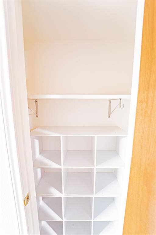 Integrated shelving system featuring cubbies and an upper shelf